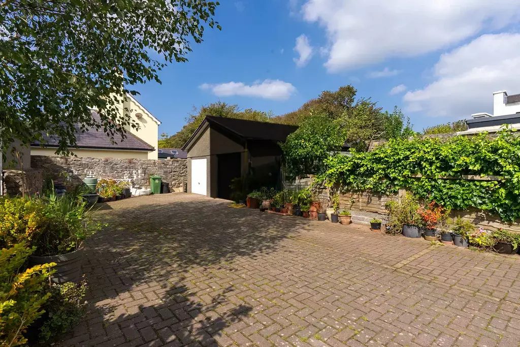 The long private driveway with garages at the end