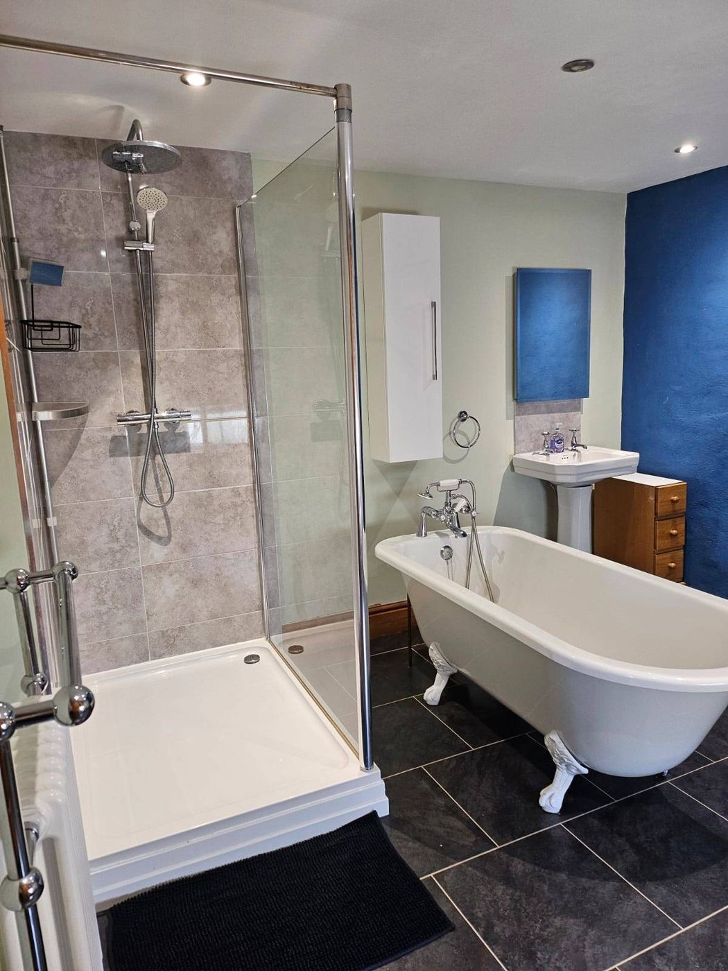 Bathroom with walk-in shower and a standalone roll-top bath