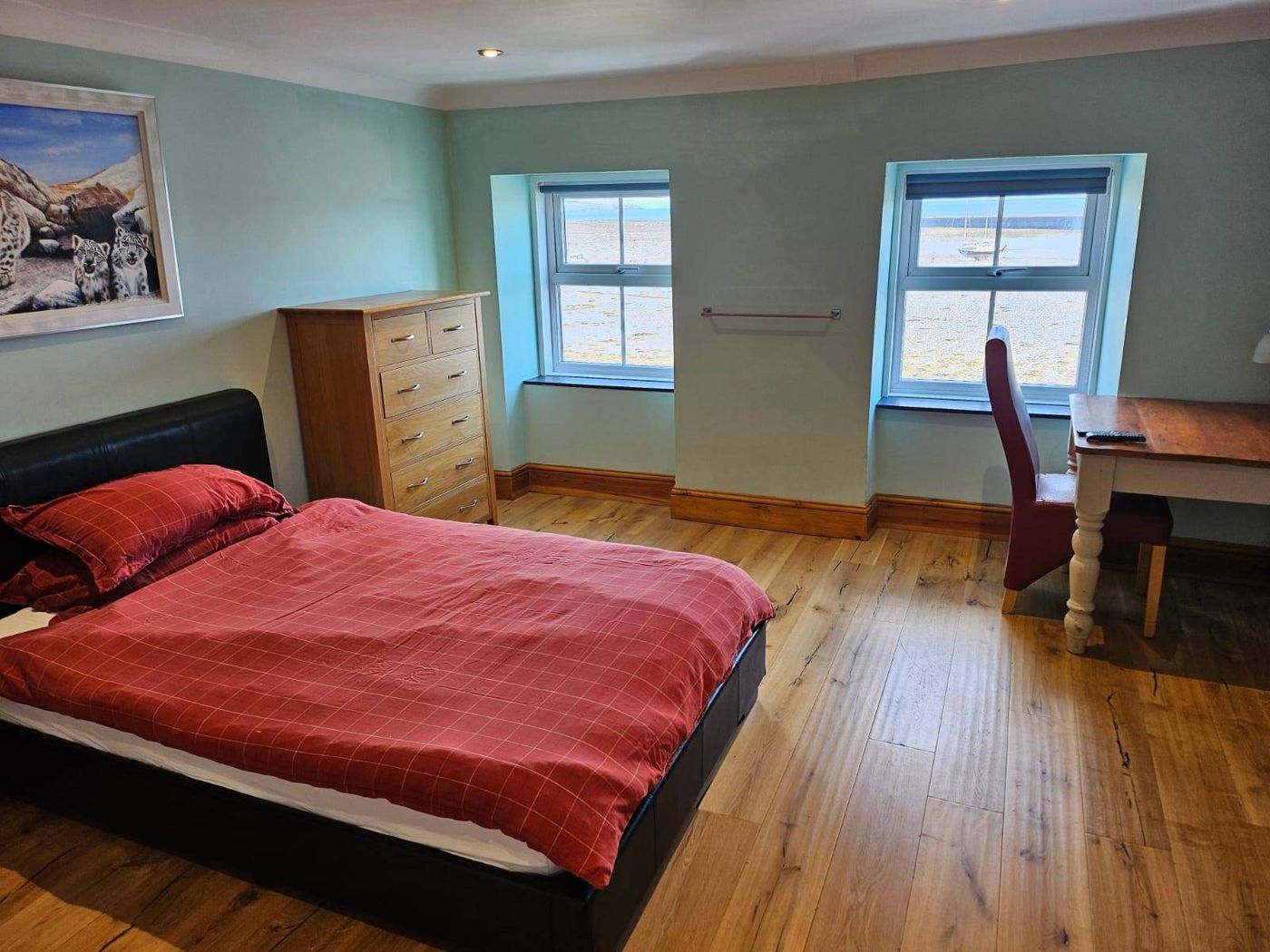 Double bedroom with wooden floor and desk