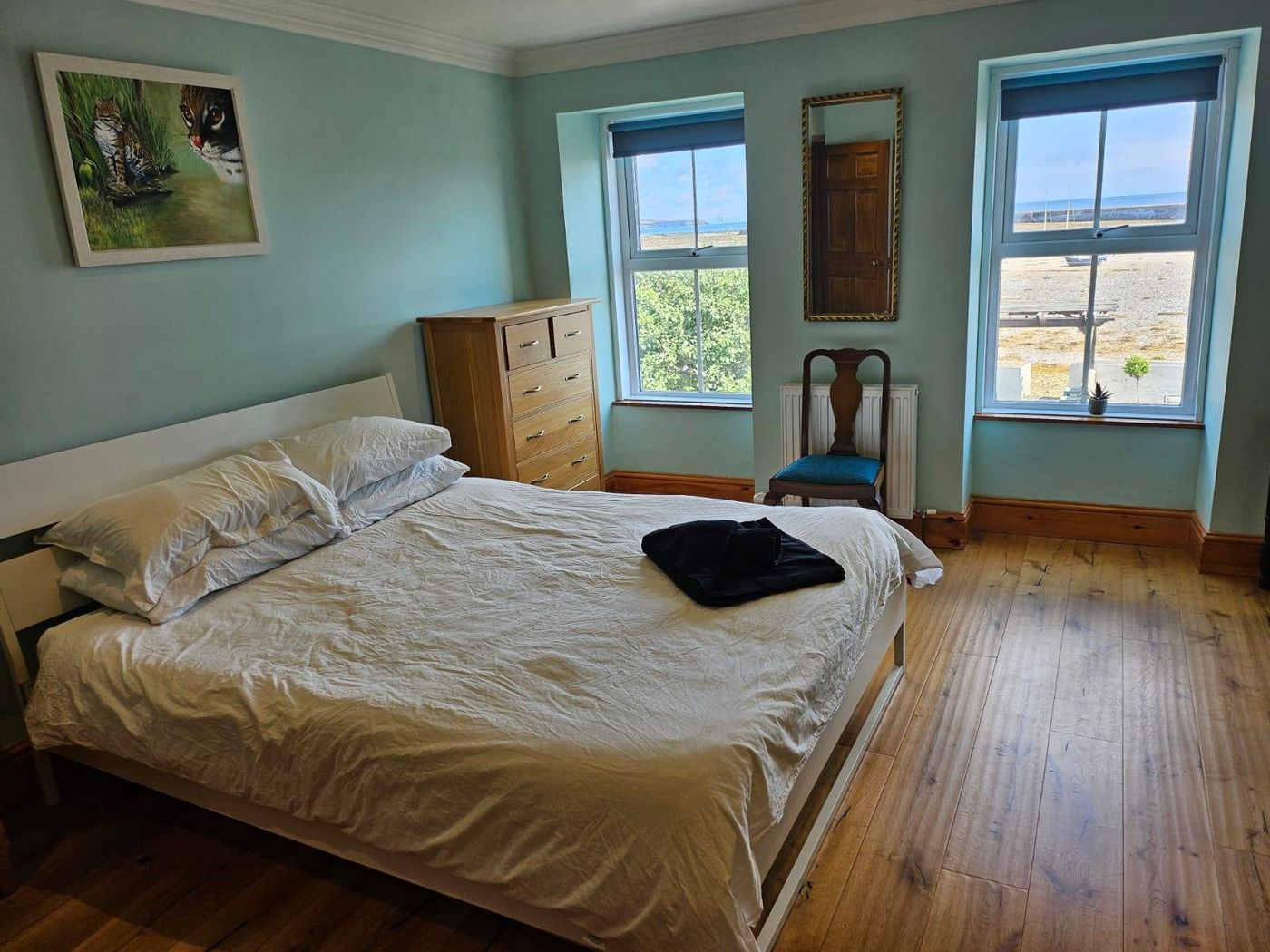 Double bedroom with windows looking out to sea