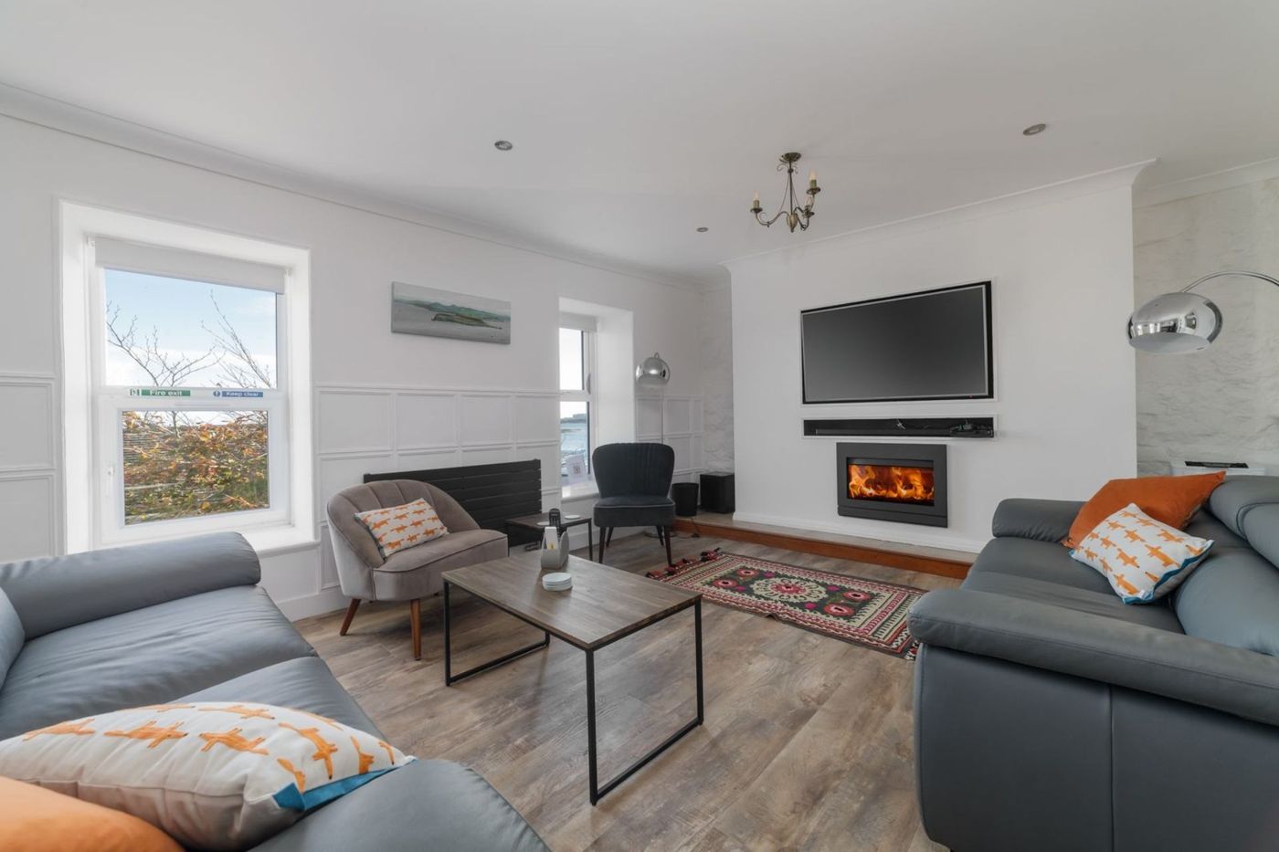 Living room with wood-burning stove and a window to the sea